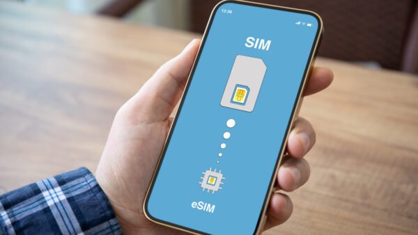 Male,hand,holding,phone,with,sim,card,replacement,on,esim